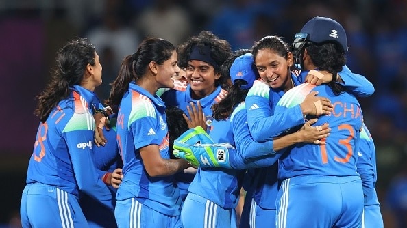 icha Ghosh of India is congratulated by team mate Harmanpreet Kaur after taking the catch to dismiss Marizanne Kapp of South Africa 
