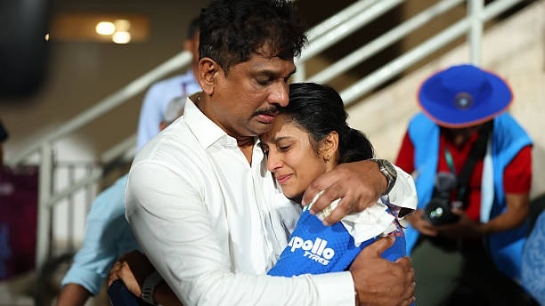 Jemimah Rodrigues of India is congratulated by Father Ivan Rodrigues,