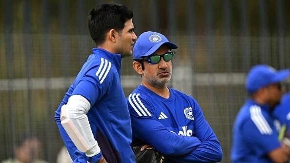 Shubman Gill (L) talks to head coach Gautam Gambhir during a practice session ahead of the first ODI cricket match against Australia