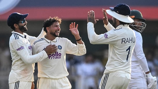 India's Kuldeep Yadav (C) celebrates with teammates