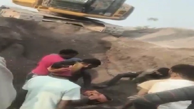 गड्ढे में दबने के बाद बच्ची को निकालते लोग. (Photo: Screengrab)