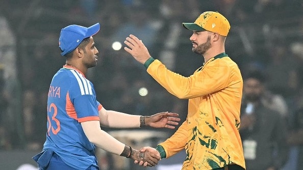 India's captain Suryakumar Yadav (L) is congratulated by his South African counterpart Aiden Markram