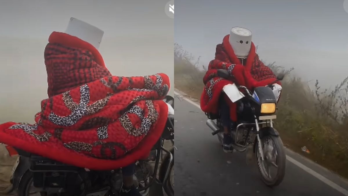 सोशल मीडिया पर एक वीडियो वायरल हो रहा है जिसमें एक व्यक्ति बाइक पर कंबल और बाल्टी की मदद से ठंड से बचने की कोशिश कर रहा है. (Photo :insta/@oc_.alpha.sp )
