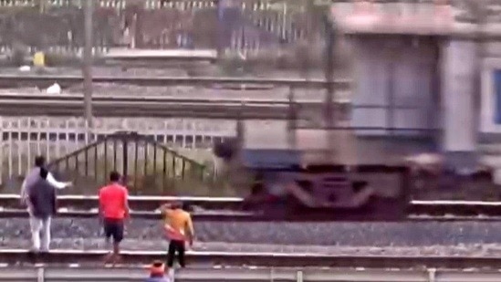 child lay on railway tracks, freight train passed over him. (Photo - Screengrab)