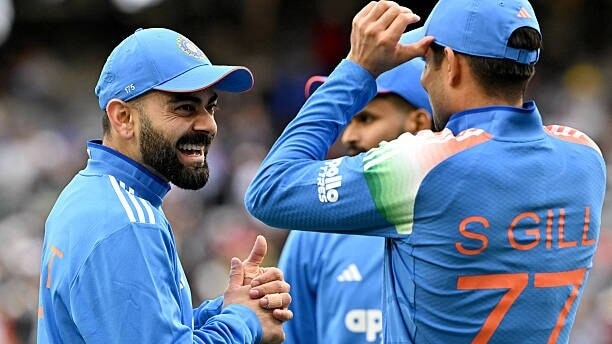 India's Virat Kohli (L) laughs as he talks with captain Shubman Gill