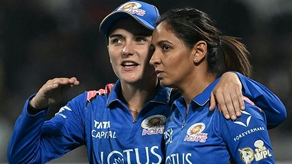 Mumbai Indians' Amelia Kerr (L) speaks with her captain Harmanpreet Kaur during the Women's Premier League (WPL) 