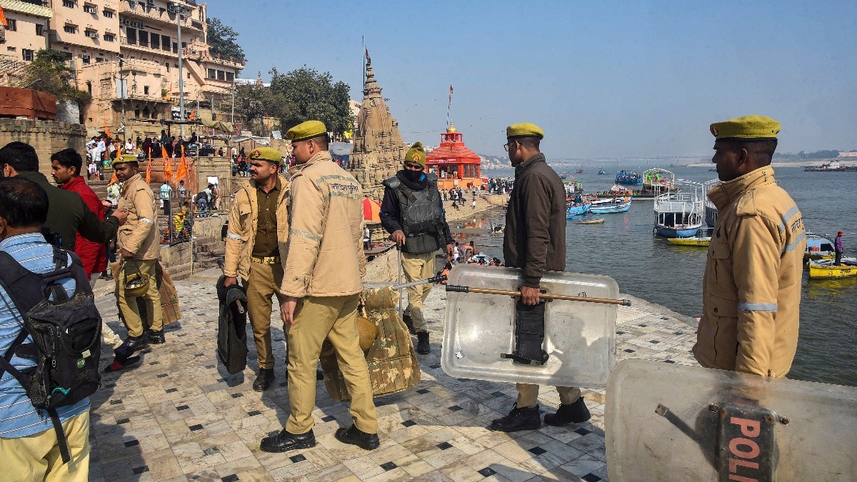 Police personnel stand guard at Manikarnika Ghat