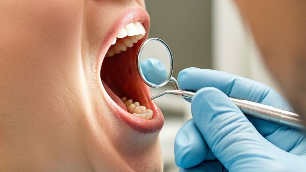 Closeup of patients open mouth during oral checkup with mirror