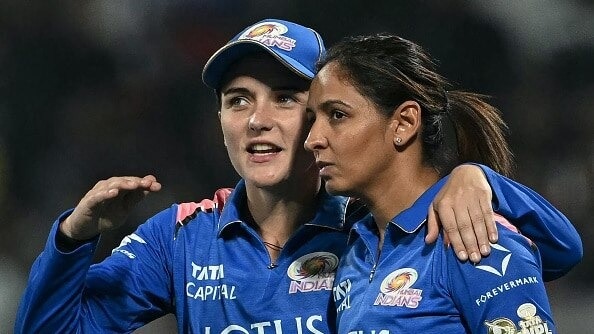 Mumbai Indians' Amelia Kerr (L) speaks with her captain Harmanpreet Kaur during the Women's Premier League (WPL) 