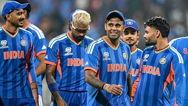 India's captain Suryakumar Yadav (C) and his teammates walk off the field
