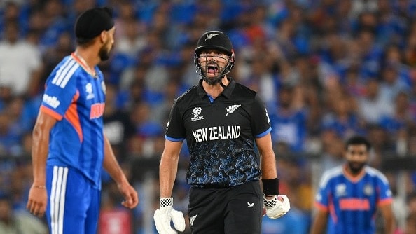 New Zealand's Daryl Mitchell (R) reacts towards India's Arshdeep Singh in this frame. (Getty)