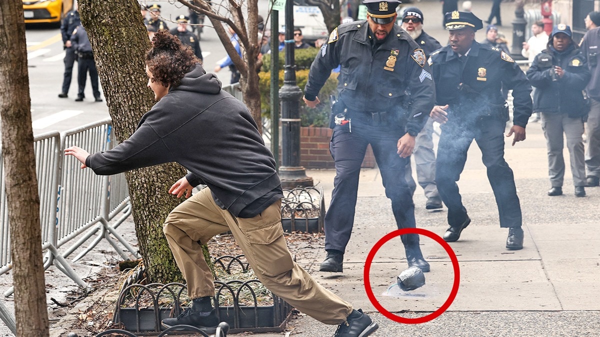 A left-wing activist flees after throwing an explosive device during a protest in front of Gracie Mansion, the New York mayor's residence