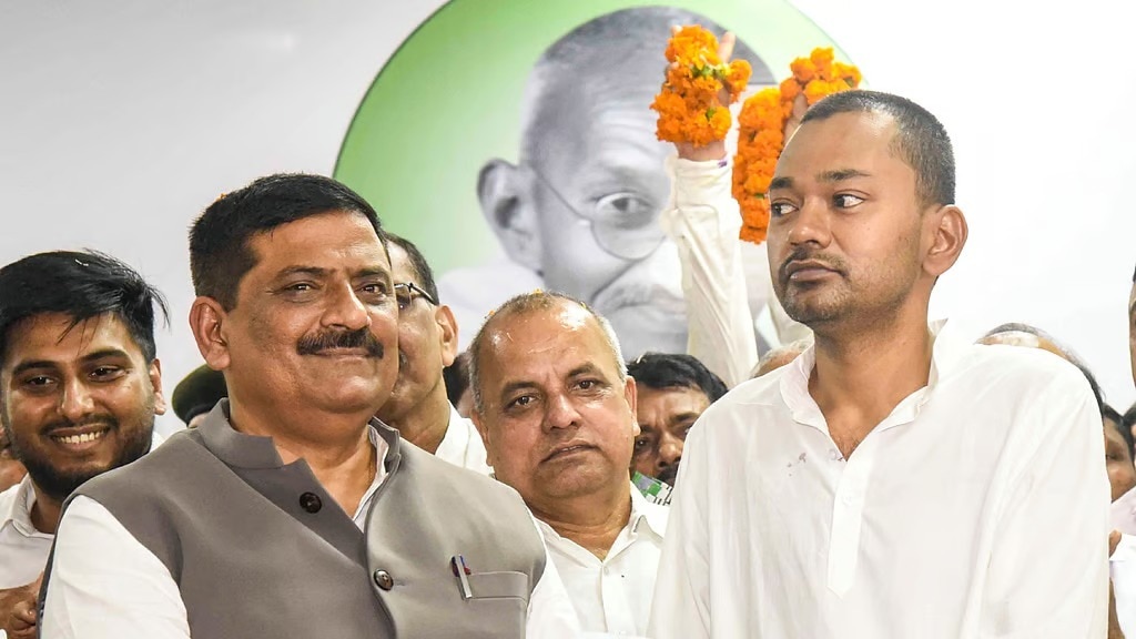 JD(U) National Working President Sanjay Jha, left, presents membership slip to Bihar Chief Minister Nitish Kumar's son Nishant Kumar as he joins the party