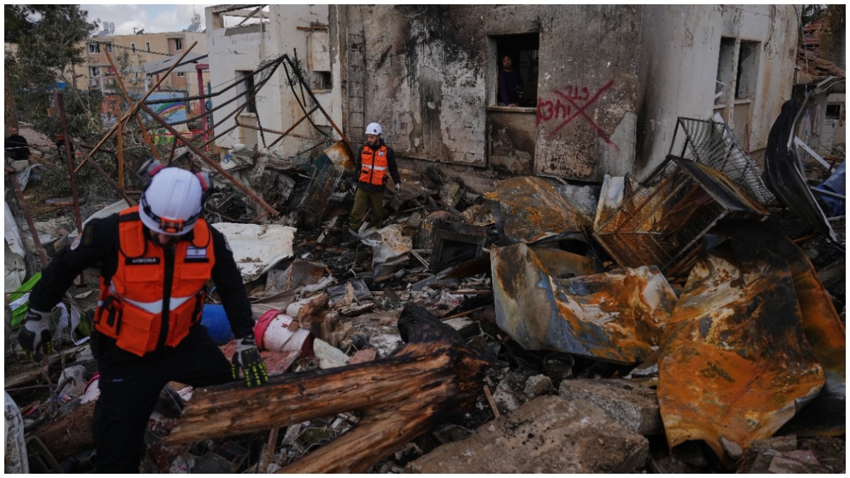 Israeli security forces survey the site that was struck by an Iranian missile in Dimona