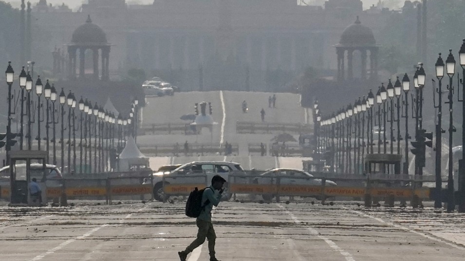 A man walks at Kartavya Path amid heat on a summer afternoon, in New Delhi (PTI Photo/Karma Bhutia)