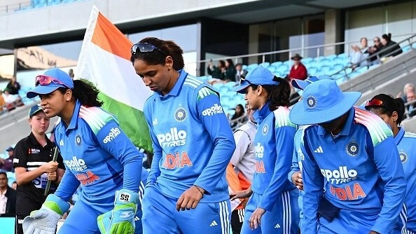 India captain Harmanpreet Kaur leads out the team