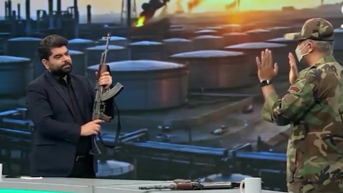 ईरानी टीवी प्रेजेंटर ने यूएई के झंडे पर AK-47 दागी. (Photo- Screengrab)