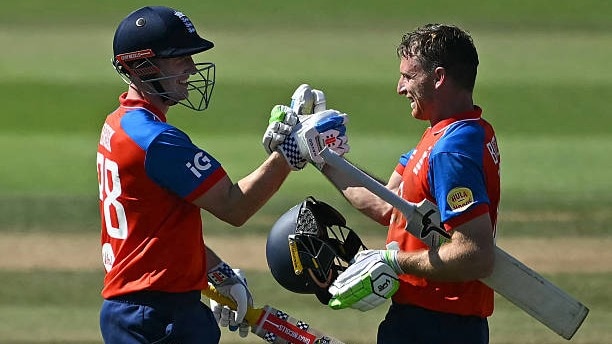 England's Jos Buttler (R) celebrates his 51-ball 100 with England's Harry Brook