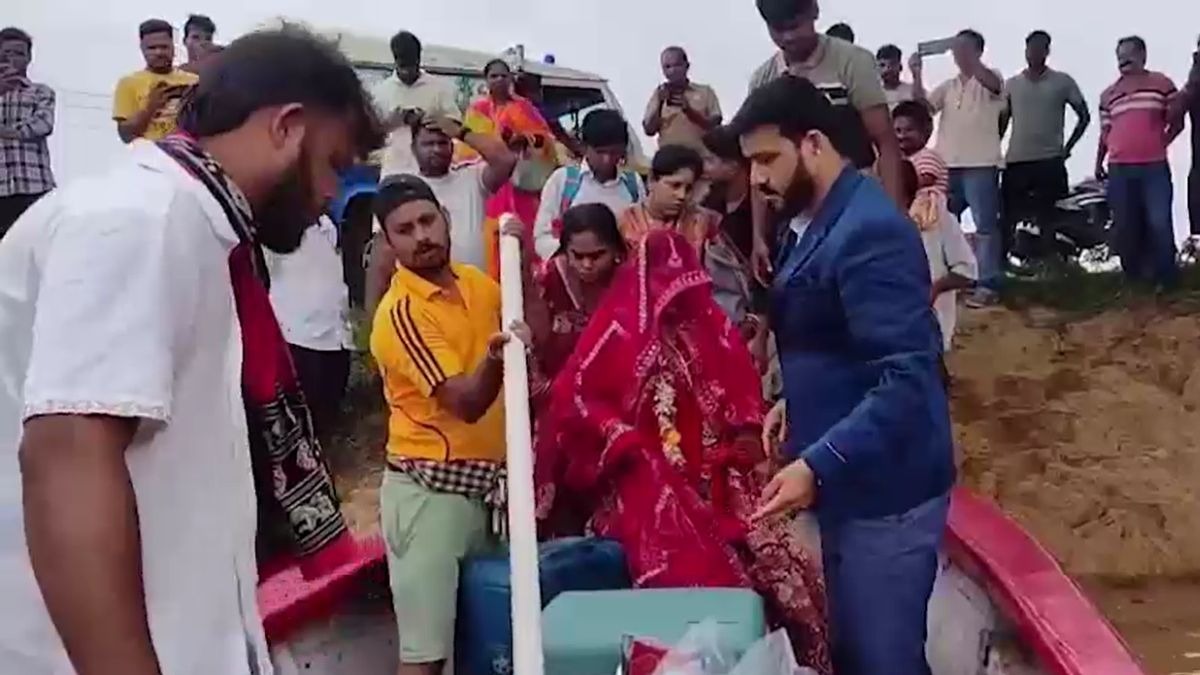 बाढ़ के बीच नाव पर सवार हुए दूल्हा-दुल्हन. (Photo: Screengrab)