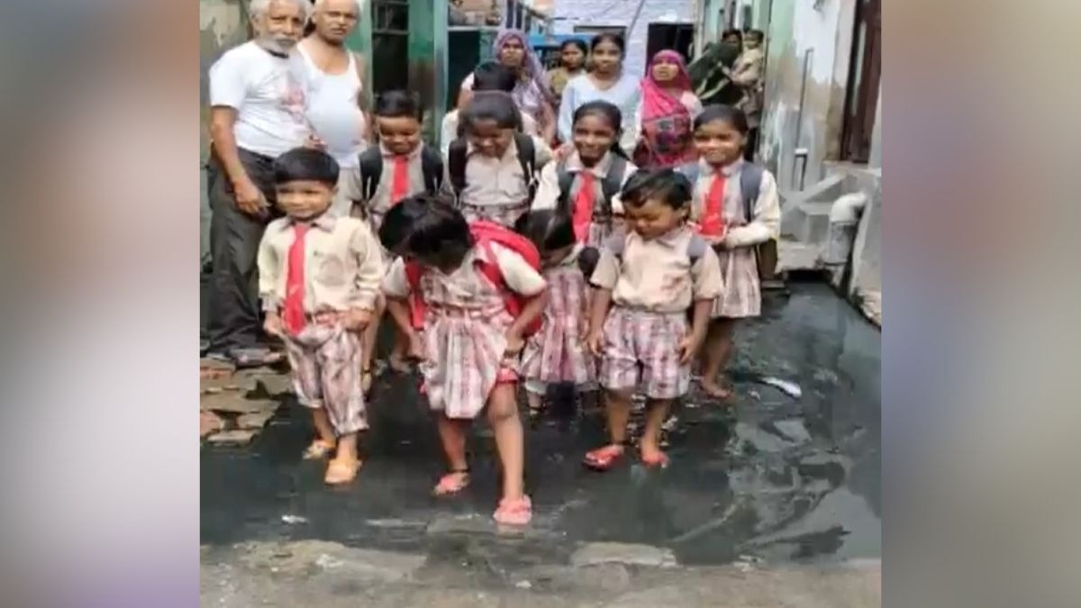सड़क पर भरे पानी से होकर जाते हैं बच्चे. (Photo: Screengrab)