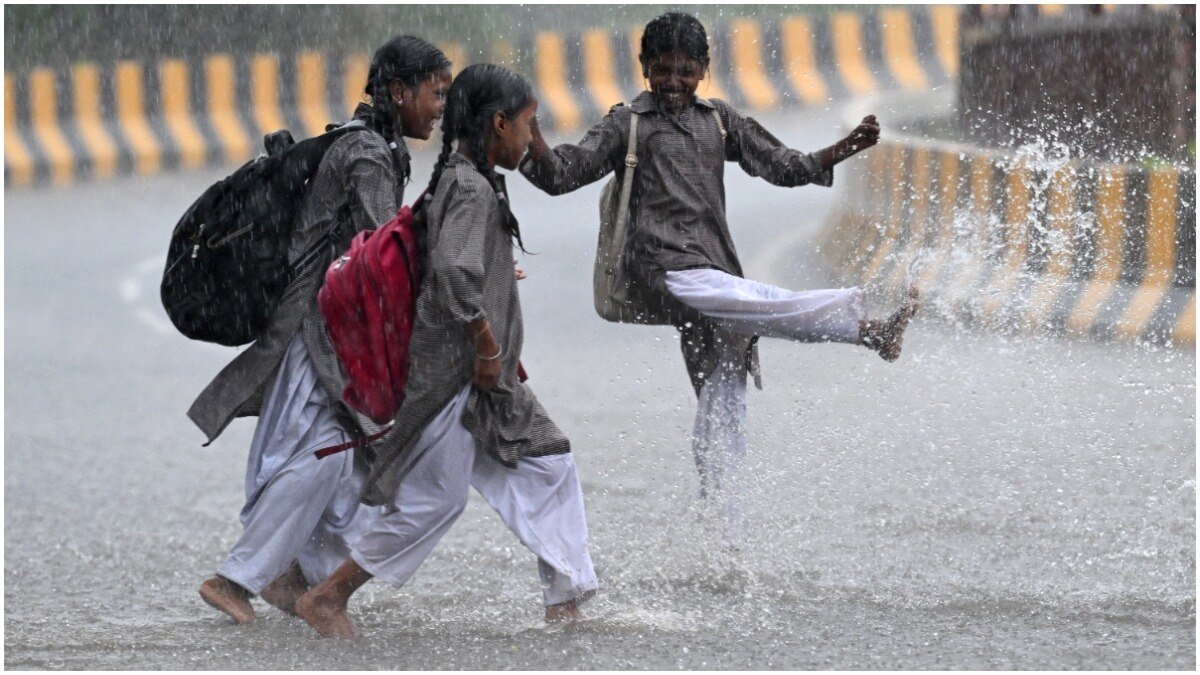 School children enjoy the rain in New Delhi 