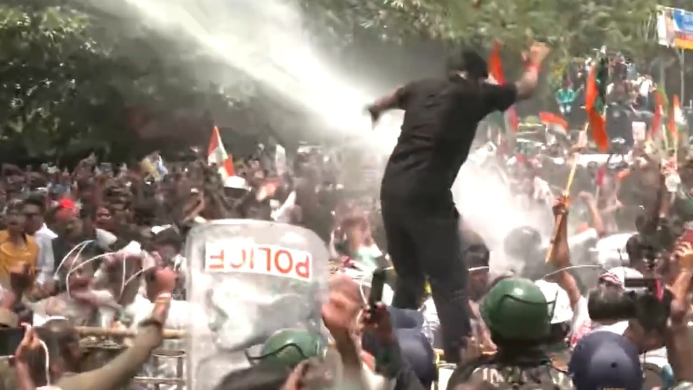 Protesters dancing under water cannon