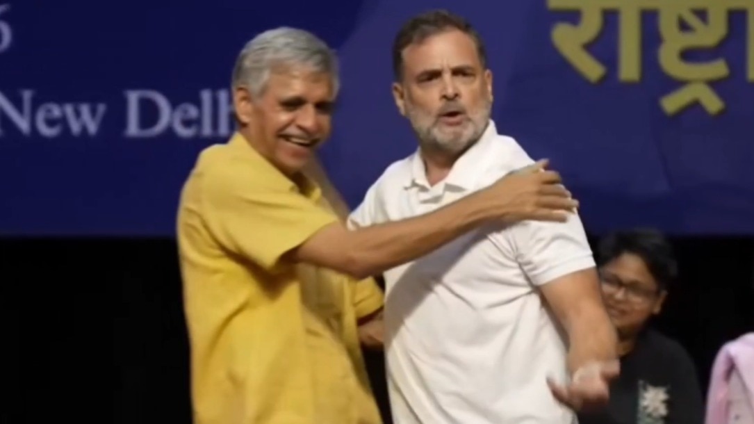 Congress leaders Rahul Gandhi and Sandeep Dikshit hug each other.