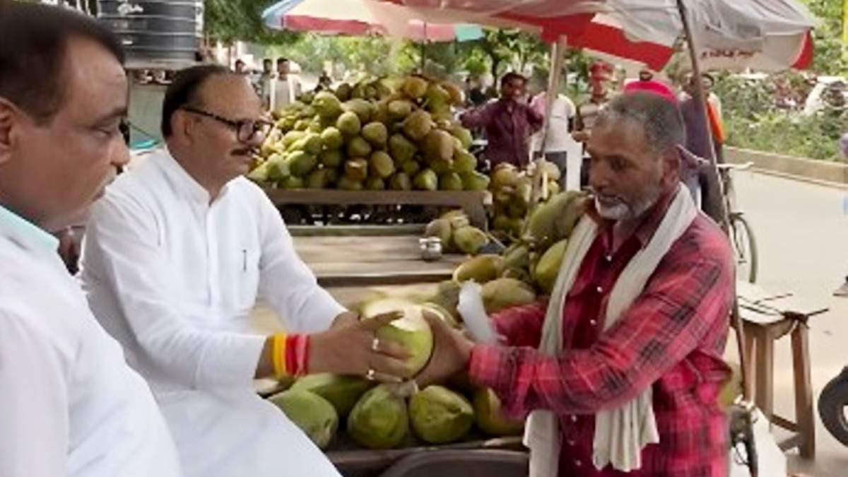 ठेले के किनारे बैठकर नारियल पानी पीते बृजेश पाठक.(Photo:Screengrab)