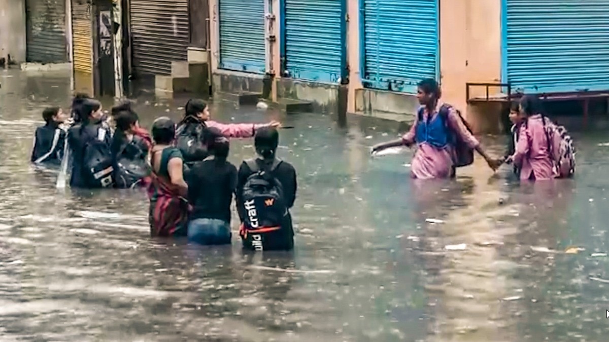 People move on a waterlogged area following rainfall, at Sangam Vihar, in New Delhi, Monday, Aug. 24, 2026. (PTI Photo)(PTI08_24_2026_000234B)