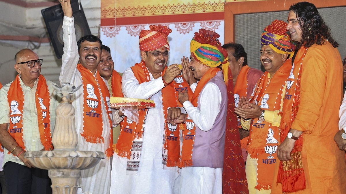 Bhajanlal Sharma offers sweets to Madan Rathore celebrating civic poll victory.