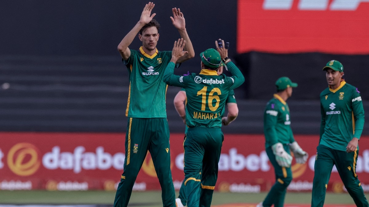 South Africa's Marco Jansen (L) celebrates with South Africa's Keshav Maharaj (2nd L) after dismissing Australia's Travis Head 