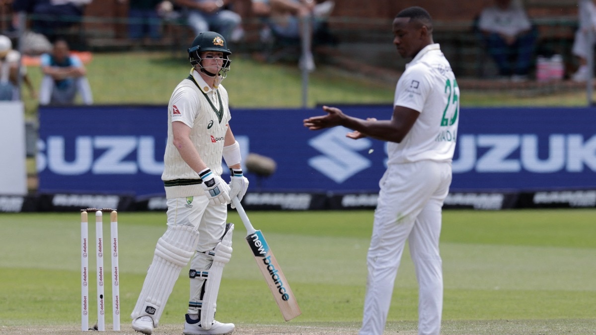 South Africa's Kagiso Rabada (R) reacts next to Australia's Steven Smith (L) on day four of the second Test match between South Africa and Australia 