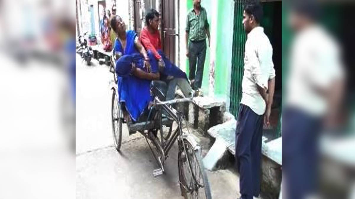 पति के शव को रिक्शे पर ले जाती हुई महिला