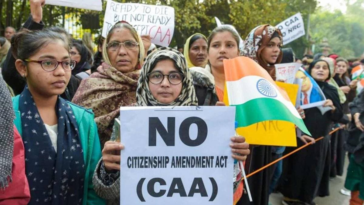 Protesters, including students and local residents, take part in a protest outside the Jamia Millia Islamia University. (Photo: PTI)
