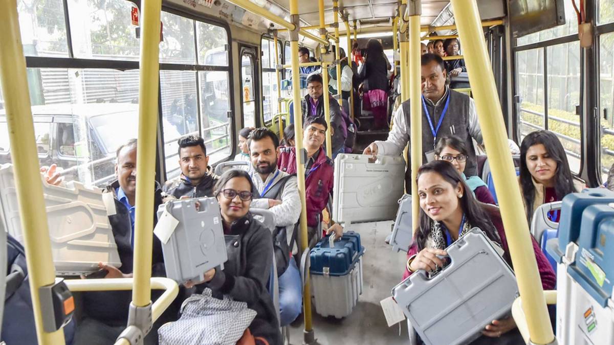 Polling officers carry EVM (PTI)