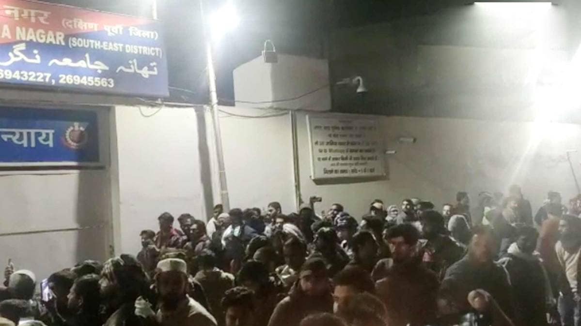 Students of Jamia Millia Islamia University and others gather outside Jamia Nagar Police station.  (Photo ANI)