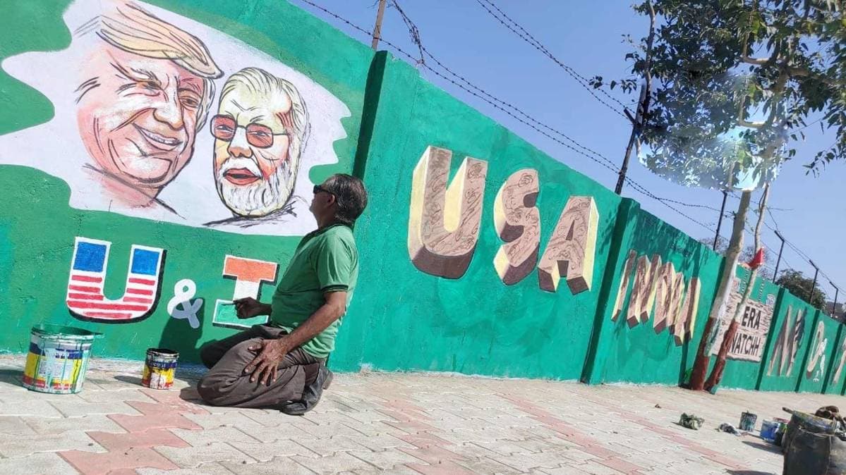 Walls opposite Motera Stadium are being painted with images of Prime Minister Narendra Modi and US President Donald Trump and slogans, ahead of US President's visit to Gujarat on 24th February.