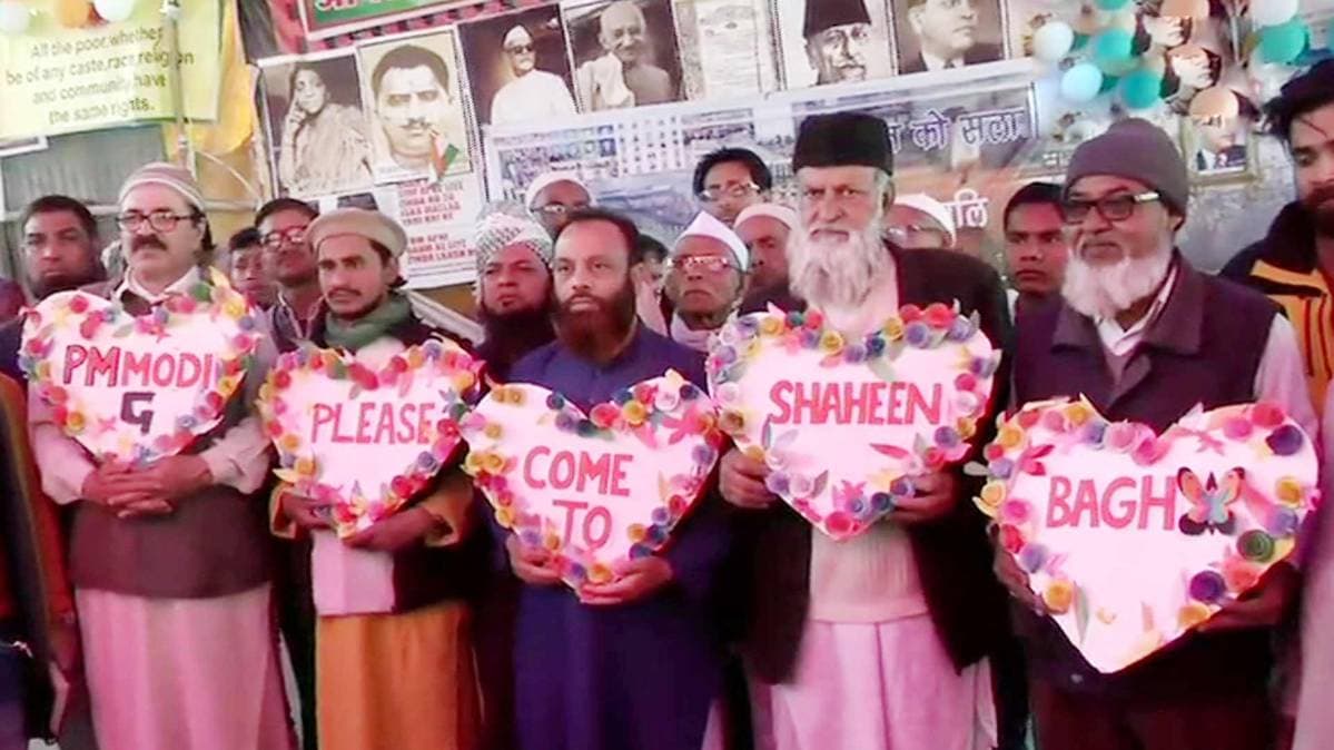 Protesters at Shaheen Bagh hold heart-shaped cutouts with 'PM Modi please come to Shaheen Bagh' written on them. Protest against Citizenship Amendment Act has been going on at the spot.