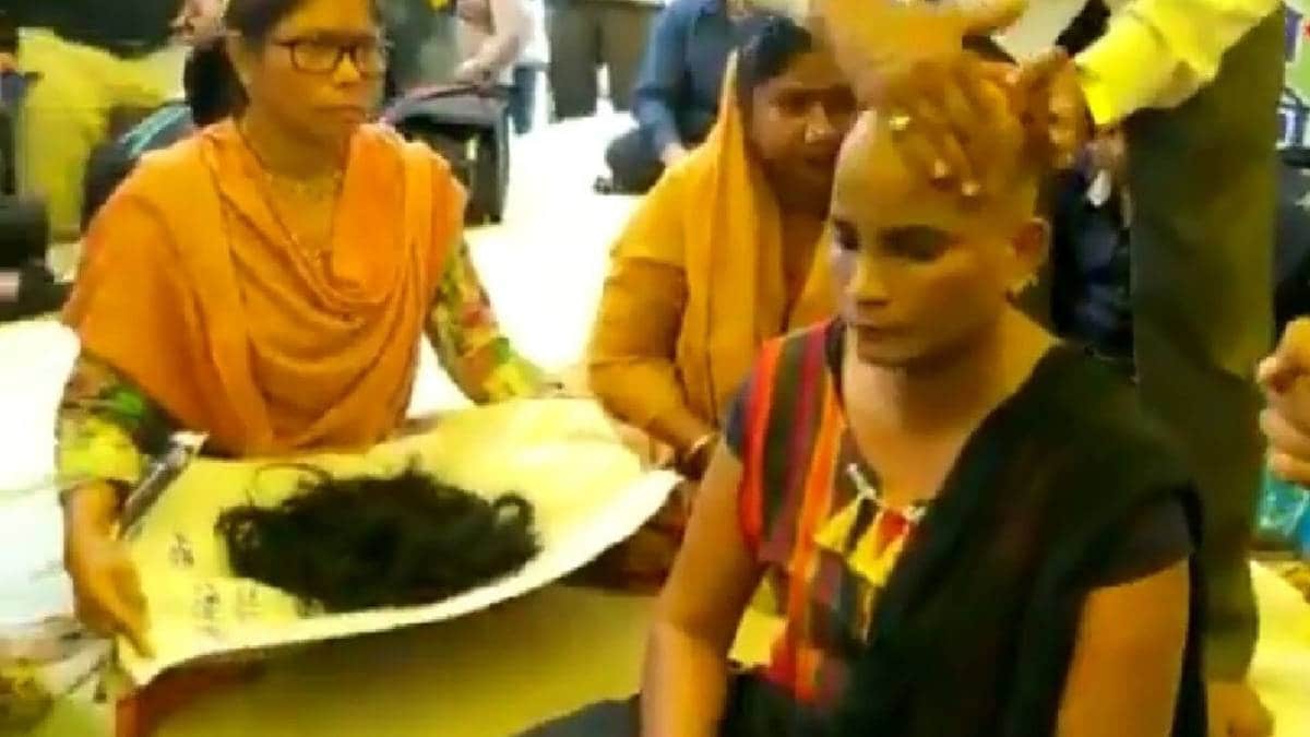 Protesting female guest teacher tonsures head