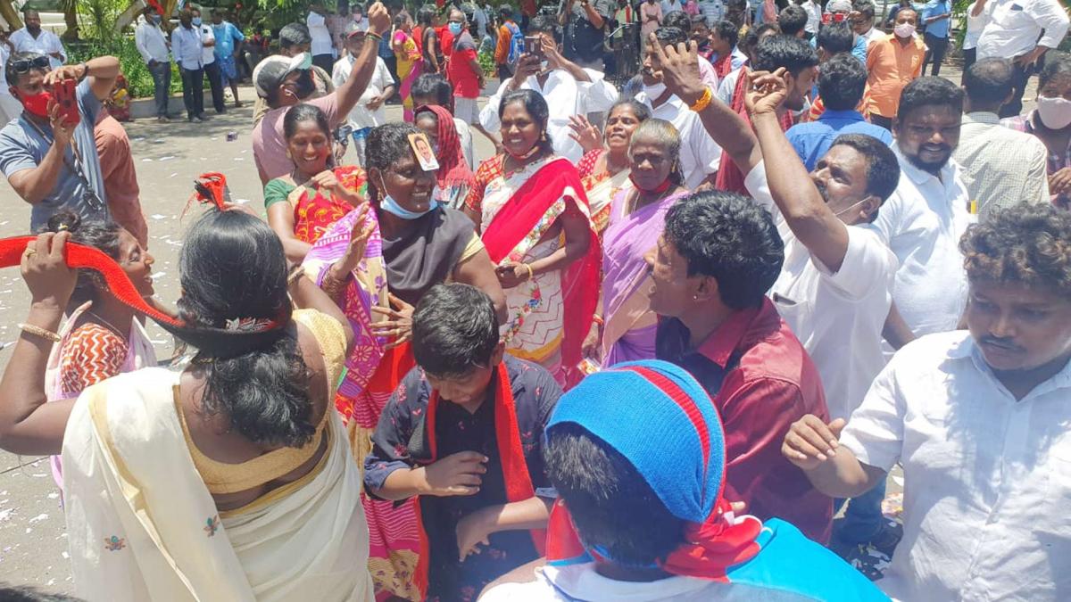 DMK supporters celebrate outside Anna Arivalayam