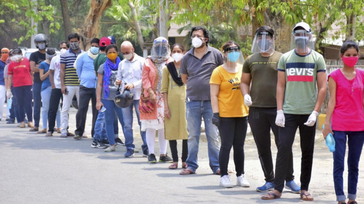 People standing in queue outside vaccination centre (File-PTI)