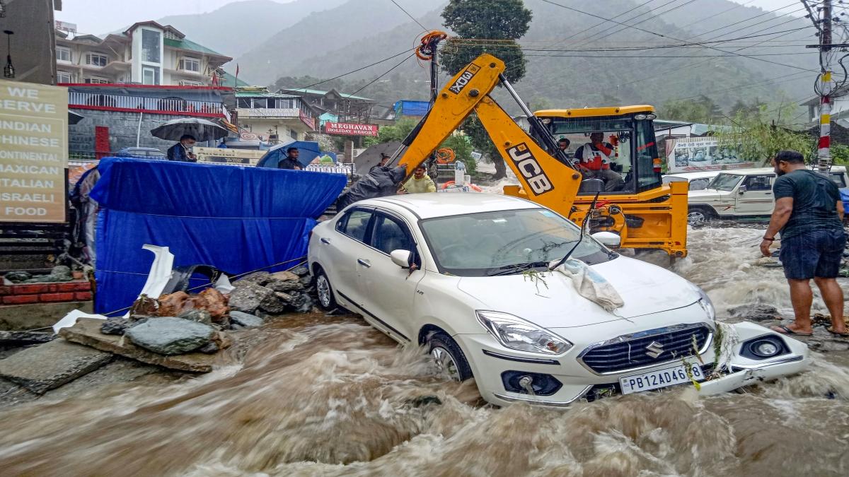 An earthmover machine taking out vehicle stuck in flood in Bhagsunag, Dharamshala.