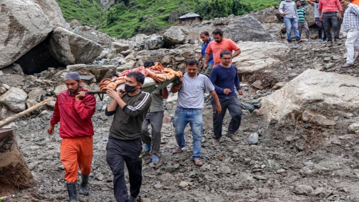 People carrying body recovered from debris in Kangra, Himachal Pradesh