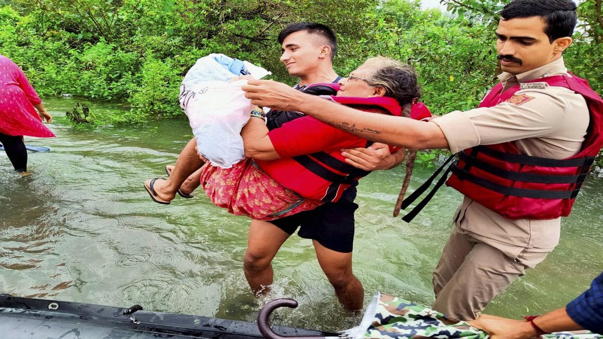 Woman being taken to safer place during rescue operation amid Mumbai flood