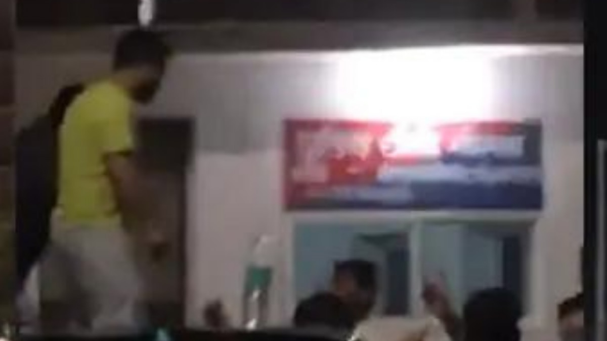 Youths dance on car near police post