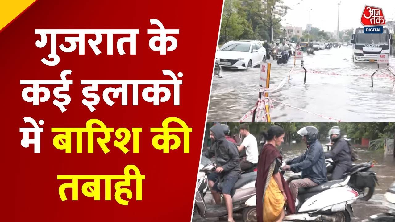 Waterlogging in Ahmedabad due to rain, vehicles stranded on the roads.