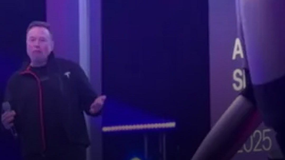 Elon Musk dances with a robot