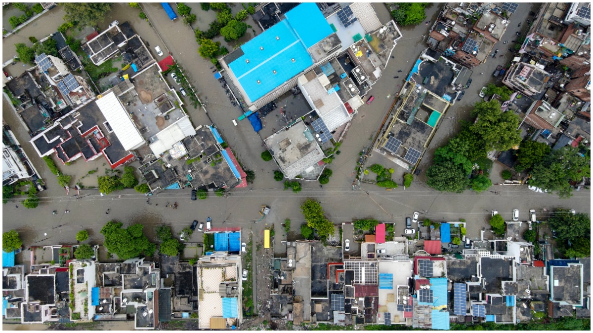 Aerial view of waterlogged residential areas and roads in Prayagraj following heavy rainfall.