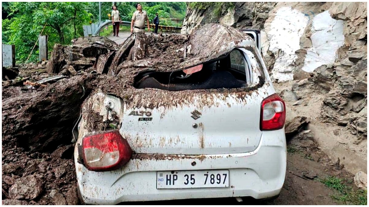 A car lies damaged after falling rocks and debris from a hillside hit it in the Anni area of Kullu district A car lies damaged after falling rocks and debris from a hillside hit it in the Anni area of Kullu district