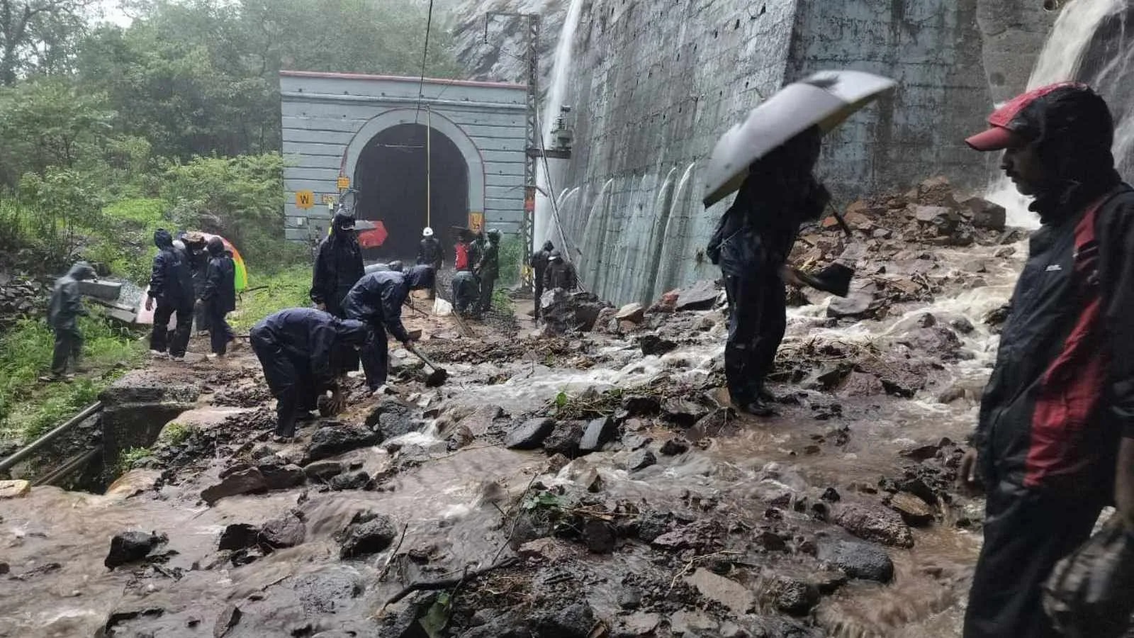 Mumbai Rains Mumbai Pune Rail Route after a landslide amid heavy rains Railway workers clear debris near Tunnel No. 40 near Bhor Ghat end on the Mumbai-Pune railway route